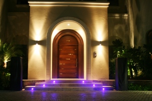An example of how lighting can enhance the visual look of your home at night. This makes the entrance look more grand and inviting.   